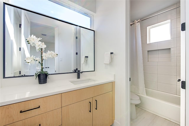 full bathroom featuring tile patterned floors, vanity, toilet, and shower / tub combo