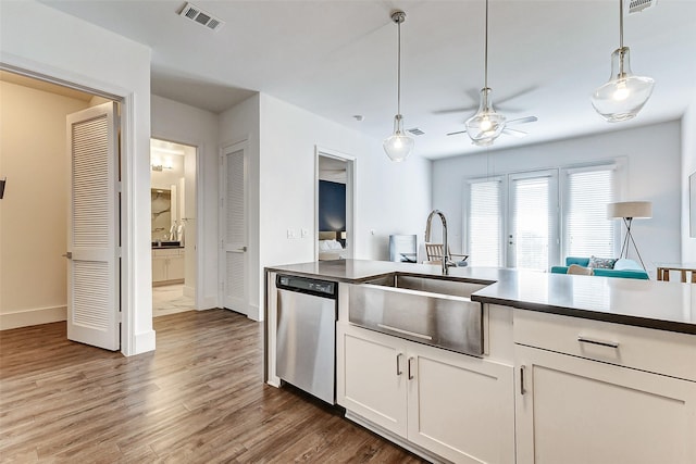 kitchen with dishwasher, white cabinets, sink, ceiling fan, and dark hardwood / wood-style flooring