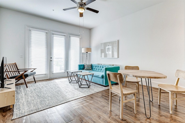 living room featuring hardwood / wood-style floors and ceiling fan