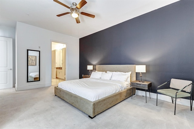 carpeted bedroom featuring ceiling fan and ensuite bathroom