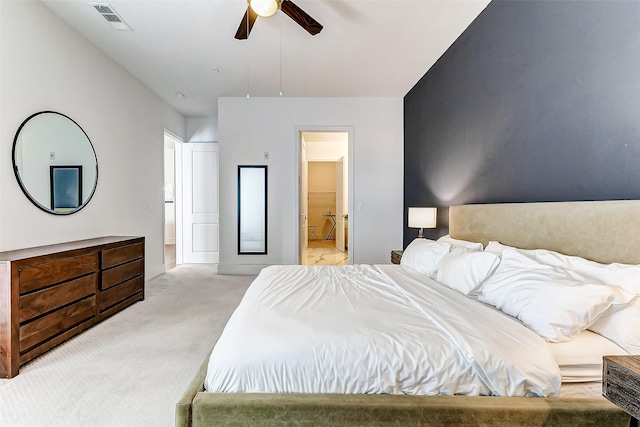 carpeted bedroom with ceiling fan and connected bathroom