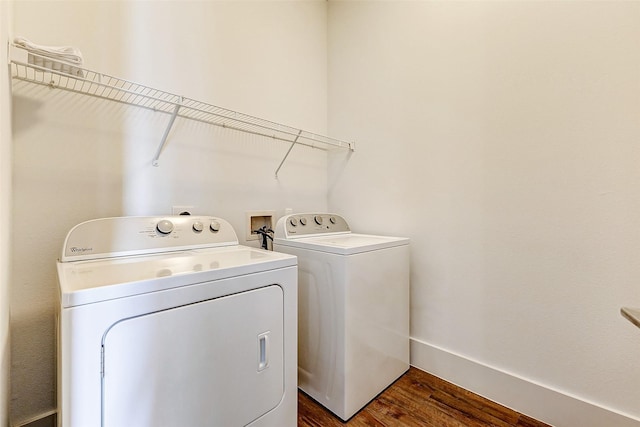 washroom featuring dark hardwood / wood-style flooring and independent washer and dryer