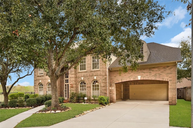 view of front of property featuring a garage and a front yard