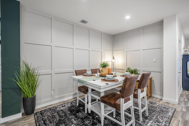 dining area featuring washer / clothes dryer and light hardwood / wood-style flooring