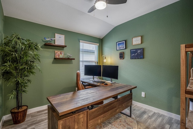 office space featuring ceiling fan, lofted ceiling, and hardwood / wood-style flooring