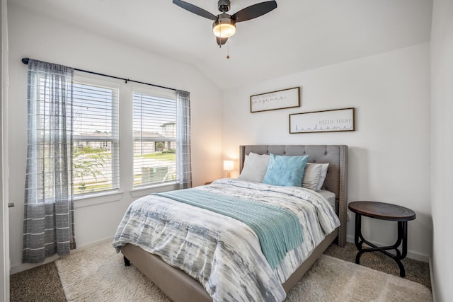 bedroom featuring ceiling fan, light colored carpet, and vaulted ceiling