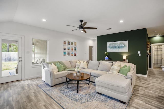 living room featuring light hardwood / wood-style floors, ceiling fan, and lofted ceiling