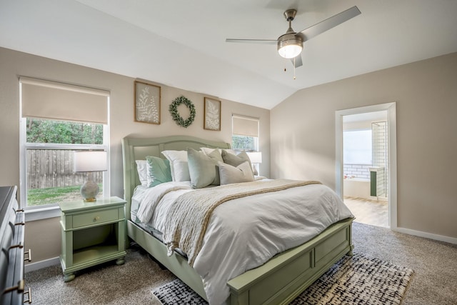 bedroom featuring carpet flooring, ceiling fan, ensuite bathroom, and vaulted ceiling