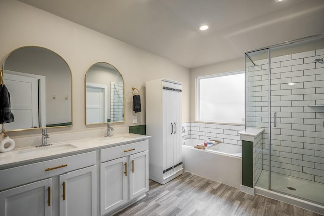 bathroom with vanity, hardwood / wood-style flooring, and separate shower and tub