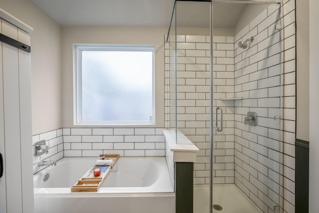 bathroom featuring plus walk in shower and a healthy amount of sunlight