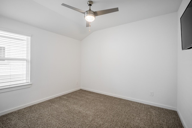 carpeted empty room featuring ceiling fan and lofted ceiling