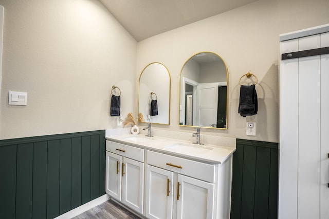 bathroom featuring vanity, vaulted ceiling, and hardwood / wood-style flooring