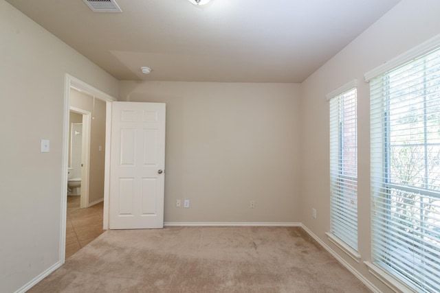 empty room with light colored carpet