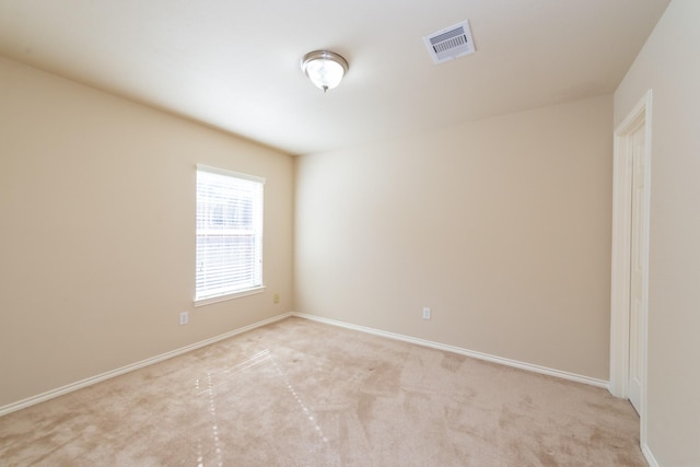 unfurnished room with light carpet