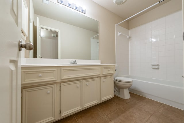 full bathroom featuring toilet, vanity, tile patterned floors, and tiled shower / bath combo