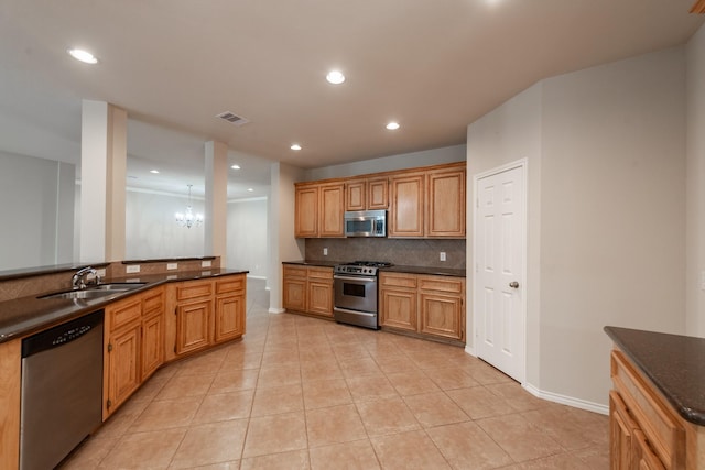 kitchen featuring sink, light tile patterned floors, tasteful backsplash, a notable chandelier, and stainless steel appliances