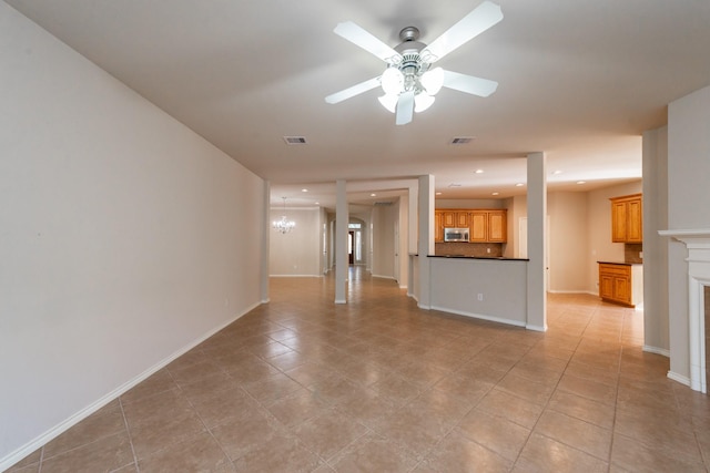 unfurnished living room featuring light tile patterned floors and ceiling fan with notable chandelier