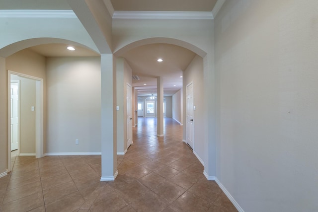 hall featuring light tile patterned flooring and crown molding