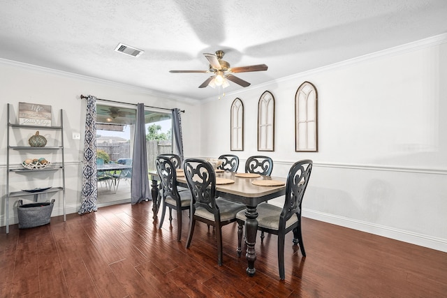 dining room featuring dark hardwood / wood-style flooring, a textured ceiling, ceiling fan, and crown molding