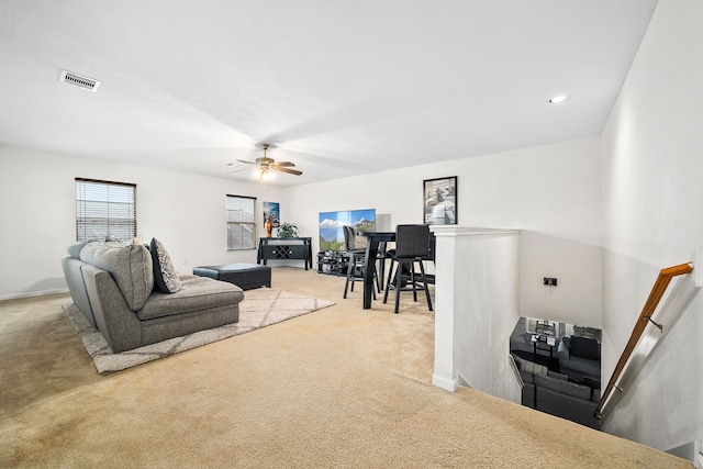 carpeted living room featuring ceiling fan