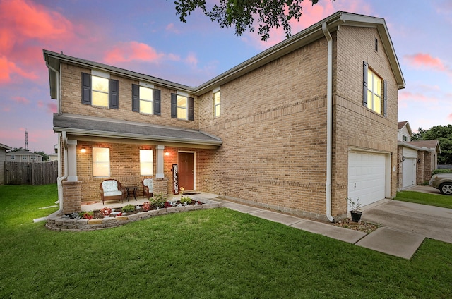 view of front of house with a porch, a garage, and a yard