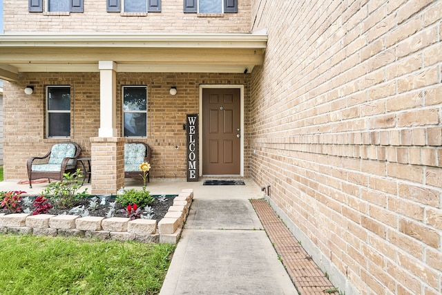 view of exterior entry featuring covered porch