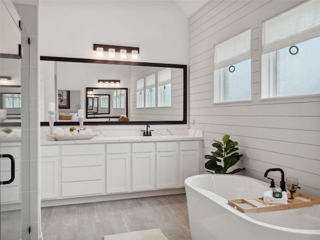 bathroom with wooden walls, vanity, and shower with separate bathtub