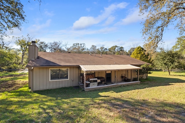 rear view of house featuring a yard and a patio