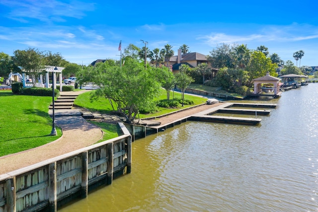 dock area with a yard and a water view