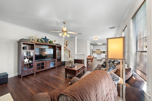 living room with crown molding, ceiling fan, and dark hardwood / wood-style floors