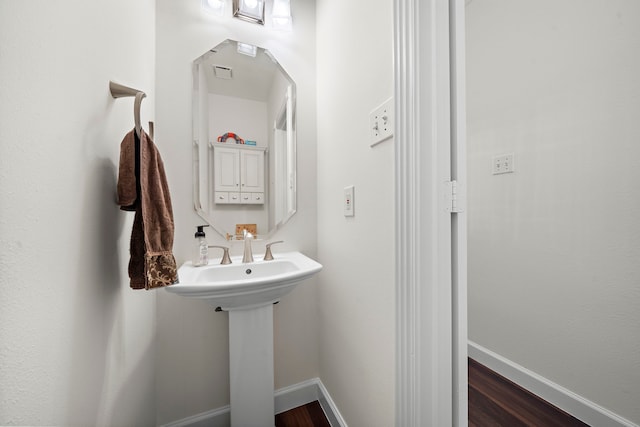 bathroom featuring wood-type flooring and sink