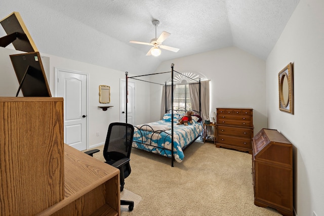 bedroom featuring a textured ceiling, ceiling fan, light carpet, and vaulted ceiling