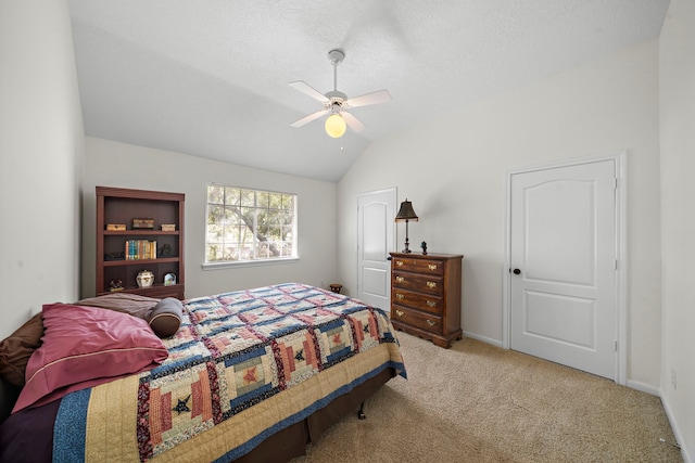 bedroom featuring ceiling fan, light colored carpet, a textured ceiling, and vaulted ceiling