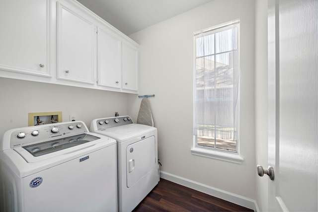 laundry room with washer and clothes dryer, plenty of natural light, cabinets, and dark hardwood / wood-style floors