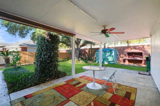 view of patio featuring ceiling fan and a storage shed