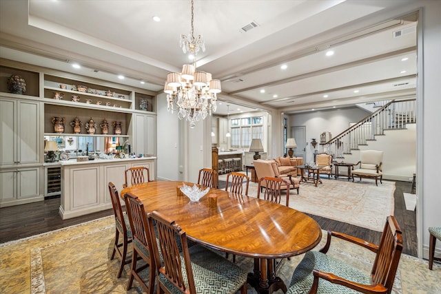 dining space featuring a notable chandelier, dark hardwood / wood-style flooring, and beverage cooler