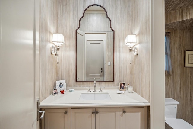 bathroom featuring vanity and toilet