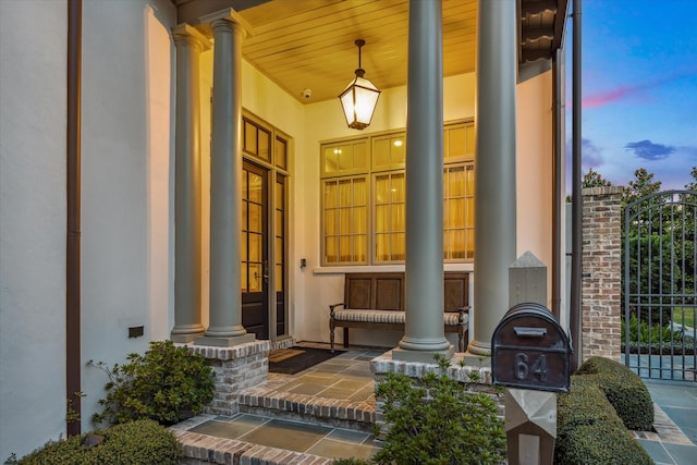 exterior entry at dusk with covered porch