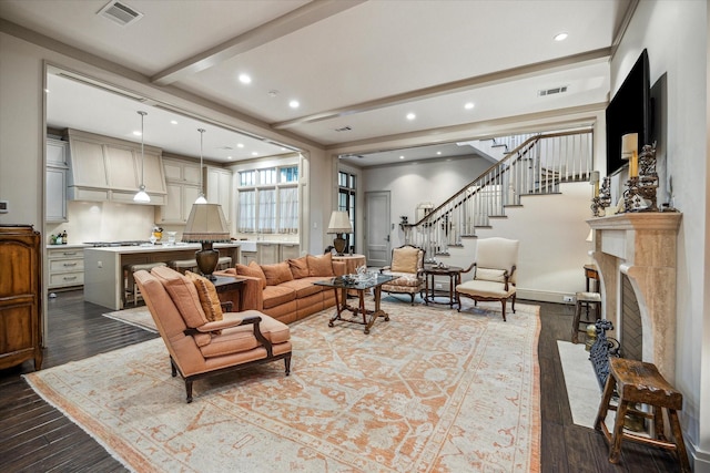 living room featuring hardwood / wood-style floors and beam ceiling