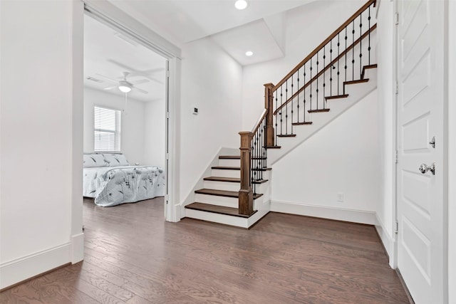 stairway featuring ceiling fan and hardwood / wood-style floors