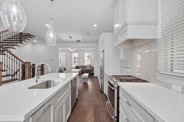 kitchen featuring white cabinetry, sink, dark hardwood / wood-style floors, and appliances with stainless steel finishes