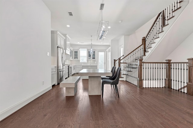 dining room with sink and dark hardwood / wood-style floors