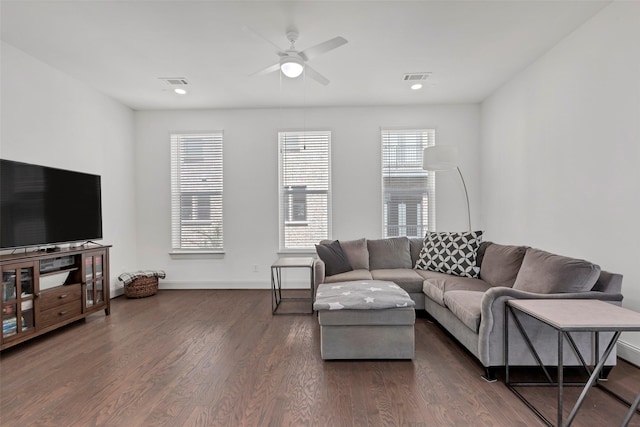 living room with dark hardwood / wood-style floors and ceiling fan