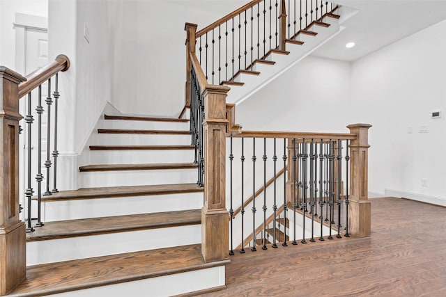 stairs with hardwood / wood-style flooring