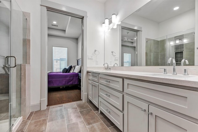 bathroom featuring tile patterned flooring, vanity, ceiling fan, and an enclosed shower