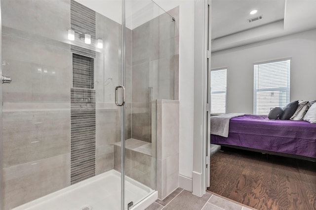 bathroom with walk in shower and hardwood / wood-style flooring