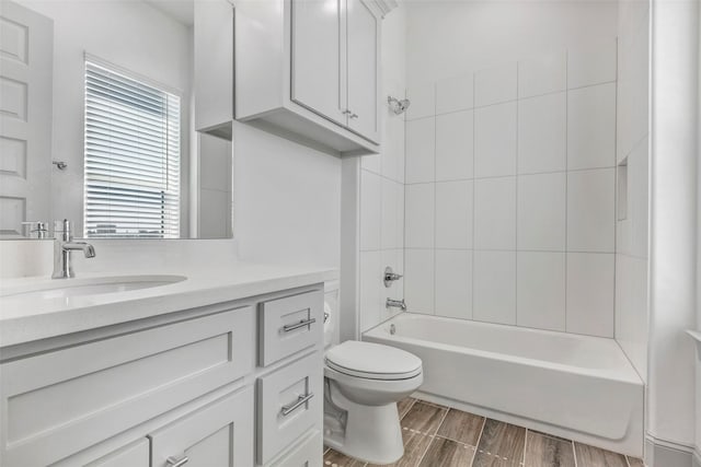 full bathroom with vanity, toilet, and tiled shower / bath