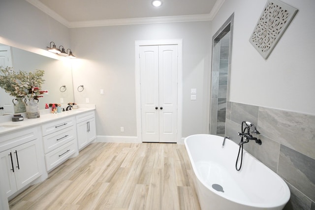 bathroom with hardwood / wood-style floors, a washtub, crown molding, and tile walls