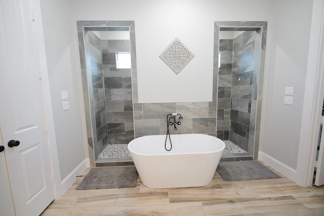 bathroom with hardwood / wood-style floors and plus walk in shower