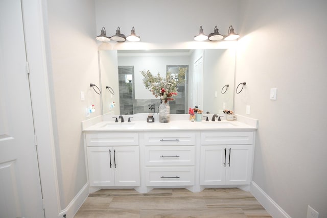 bathroom with hardwood / wood-style floors and vanity